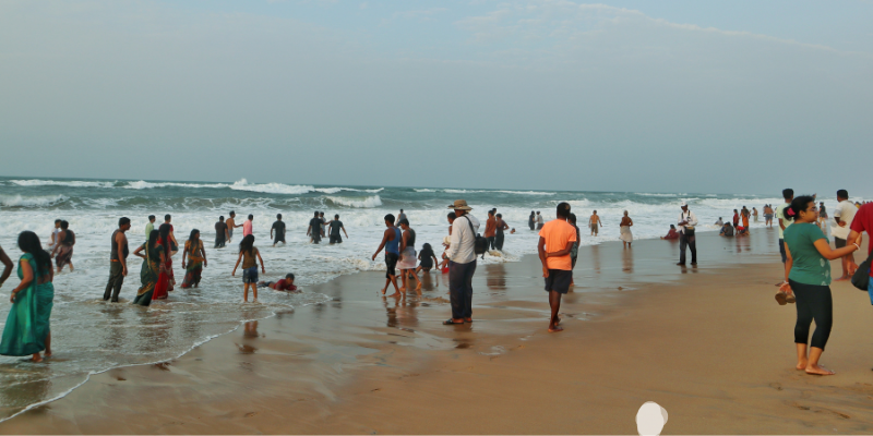 People on a beach in Puri, Odisha. Photo by Sudeshna Sahoo on Unsplash.