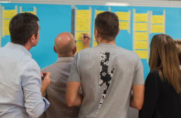 People brainstorming ideas together onto a board